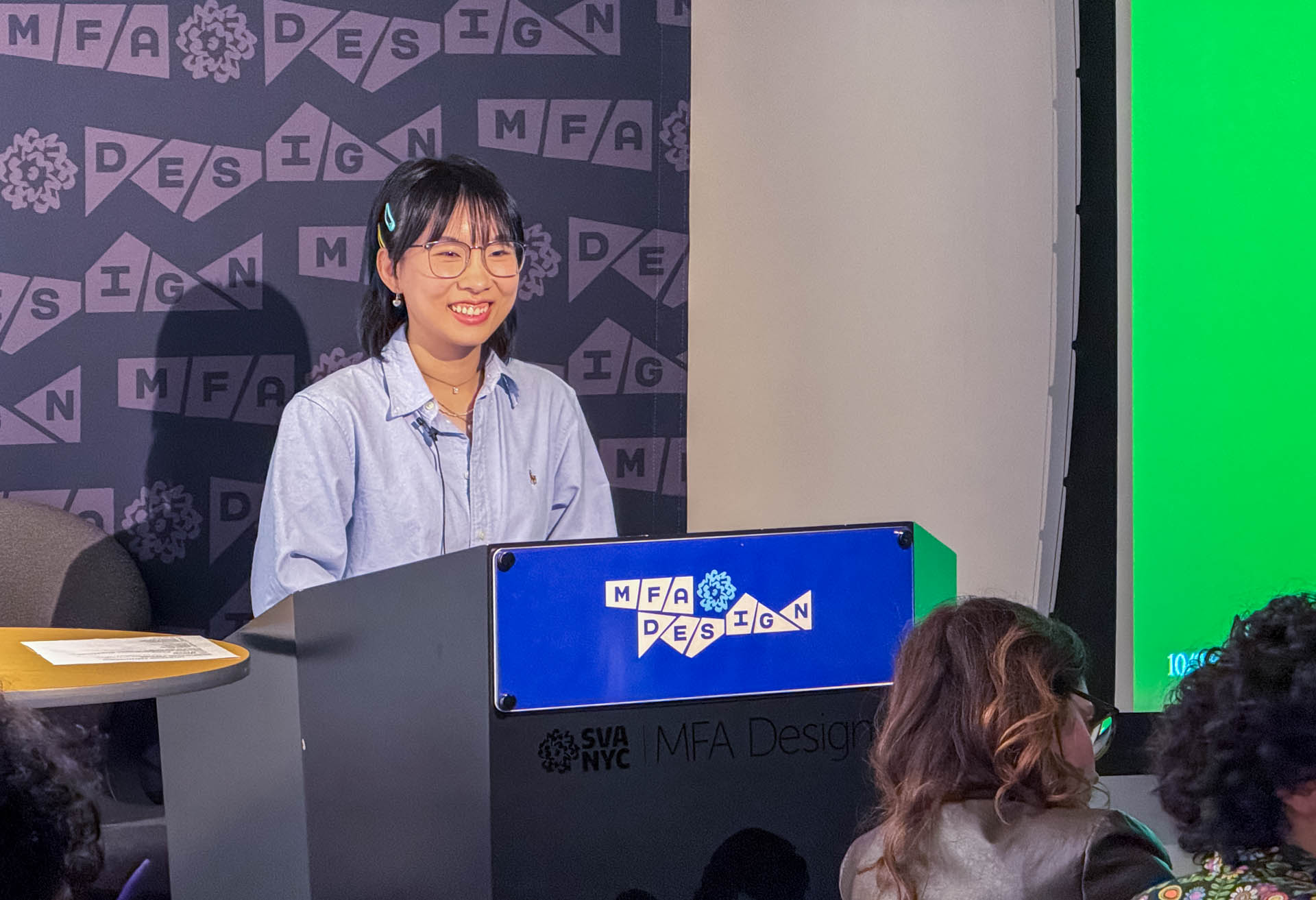 Student standing at the podium presenting Thesis work slideshow