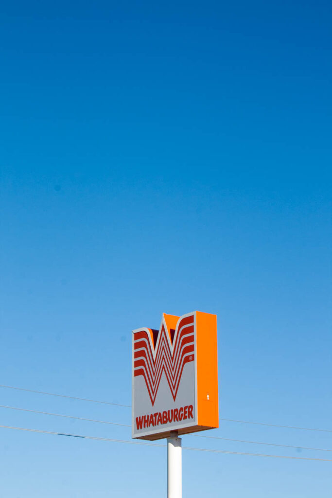 big orange fast food sign in sky