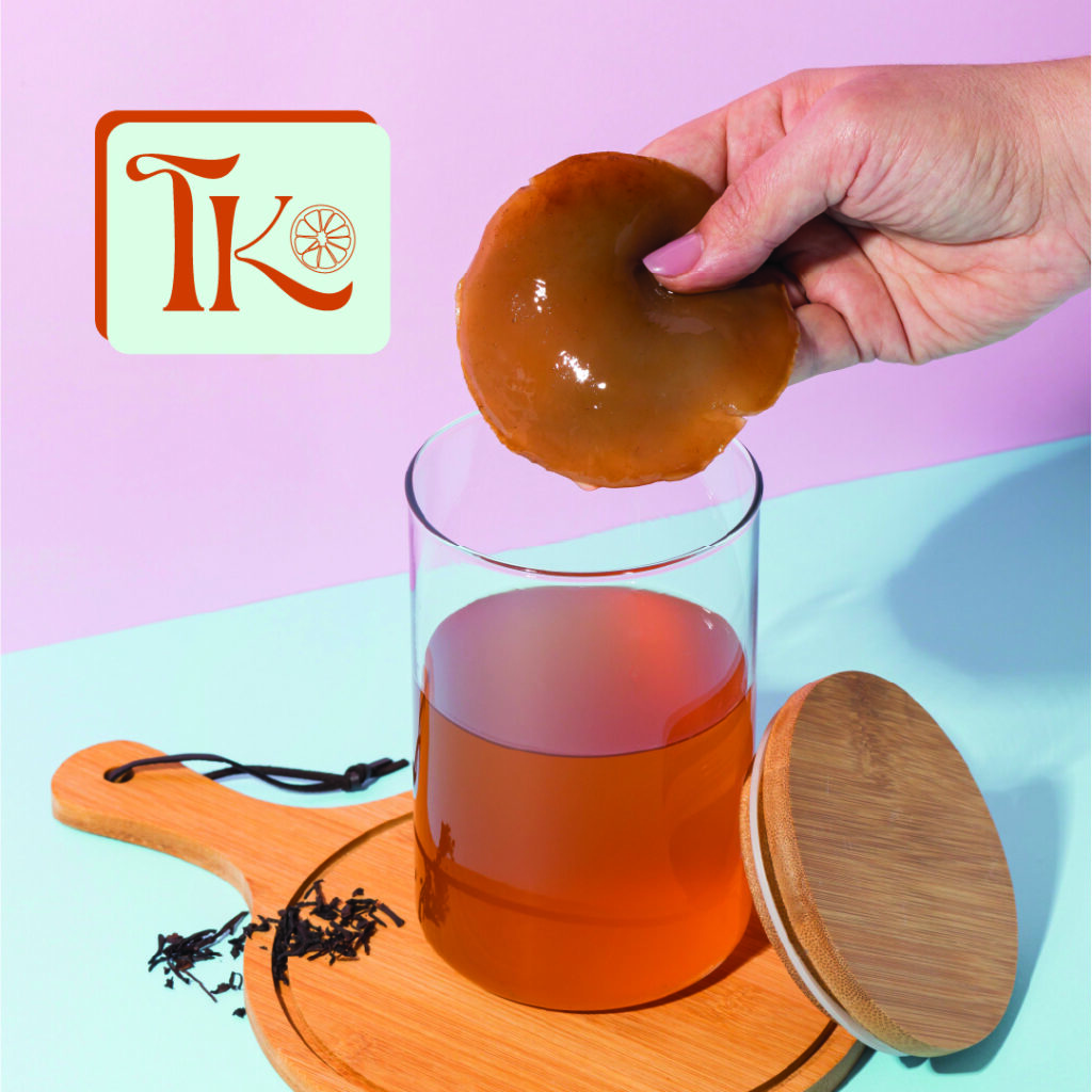 glass of kombucha with TK logo for True Kombucha
