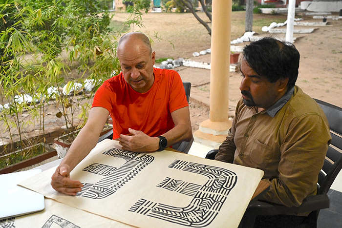 two people discussing Indian handcrafted lettering
