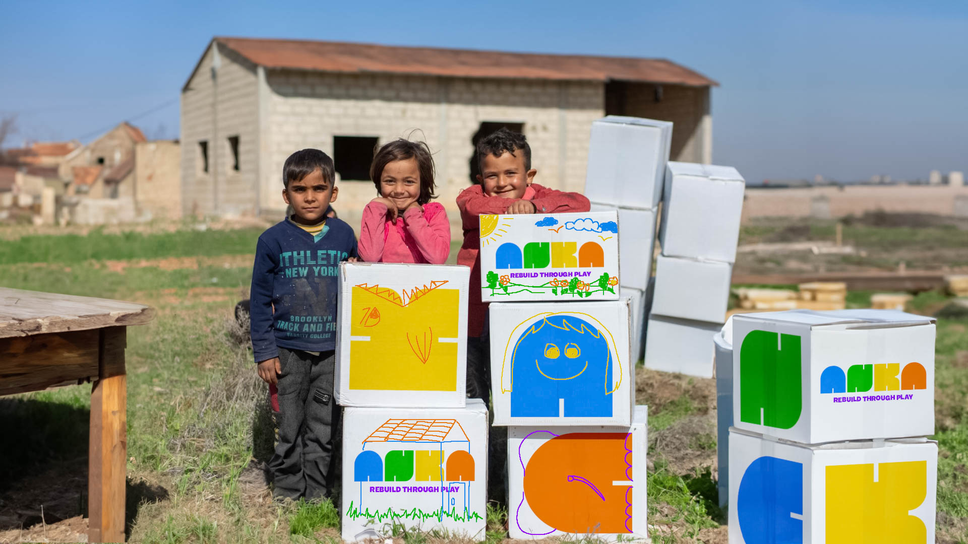 three kids outside with boxes with the colorful ANKA venture project