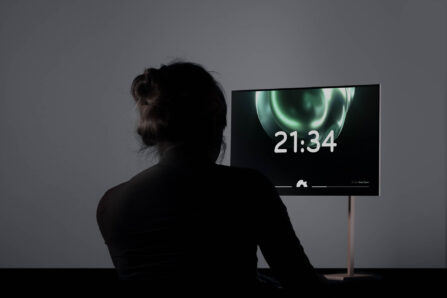 person and screen showing the time 21:34