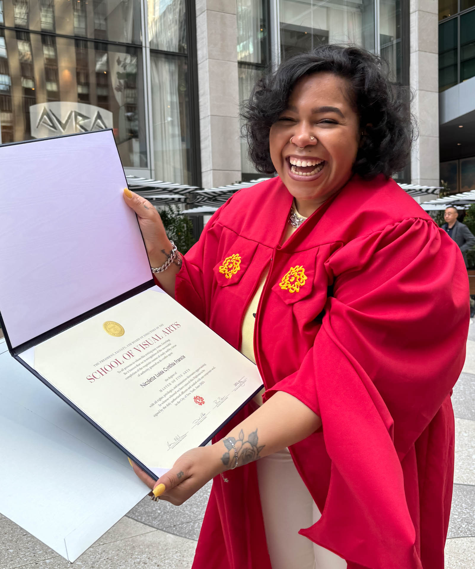 One student showing her diploma