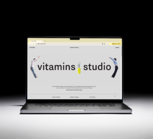 a laptop open to a webpage that says Vitamins studio