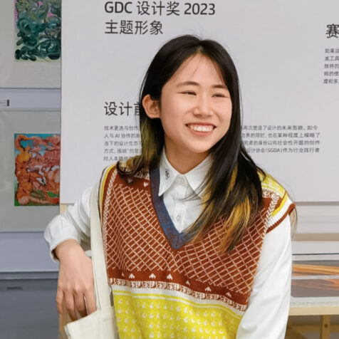 portrait of woman in a museum setting, smiling at the camera