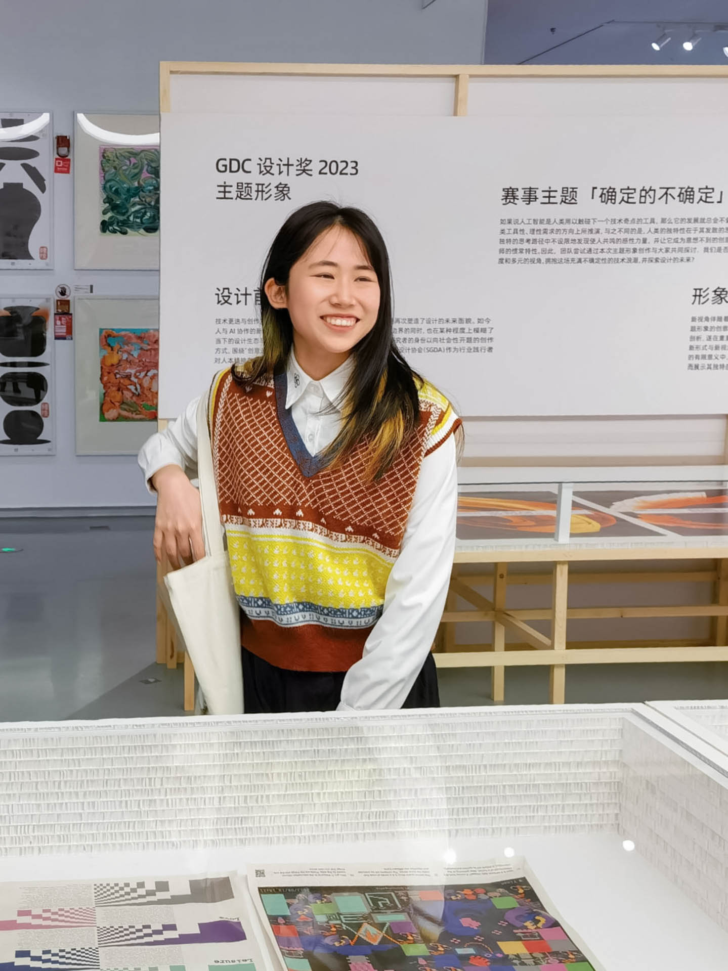 a woman with long hair in front of a museum display