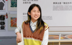 a woman with long hair in front of a museum display