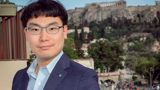 man standing in front of Acropolis