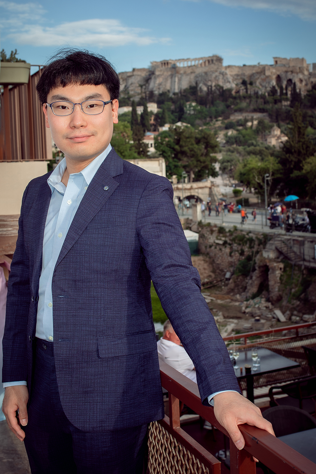 a man standing in front of the acropolis