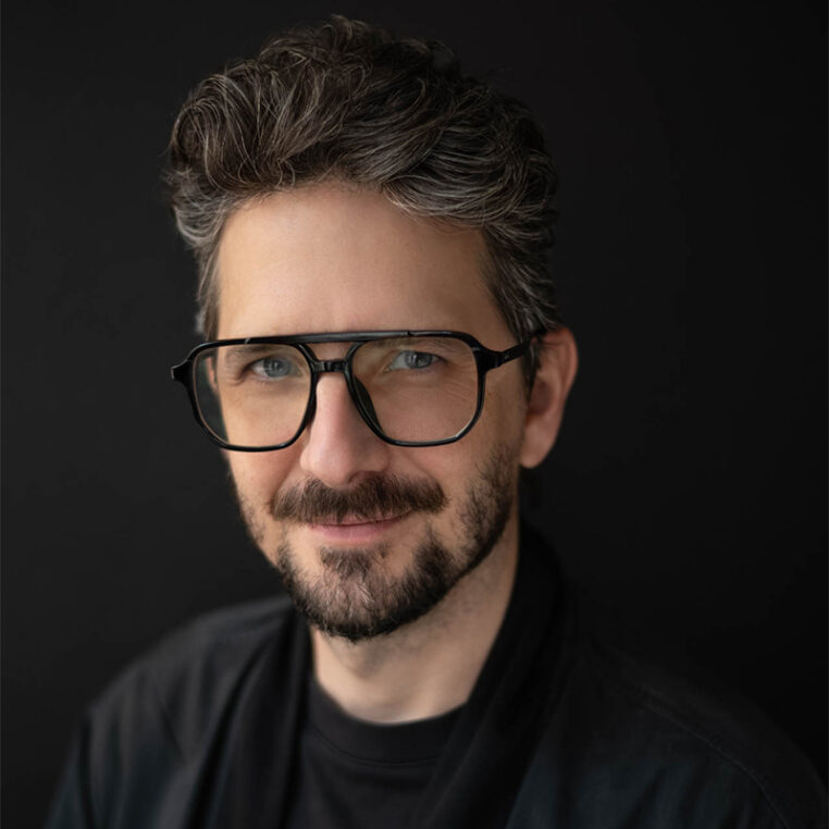 portrait of a man with glasses, Randy Hunt, black background