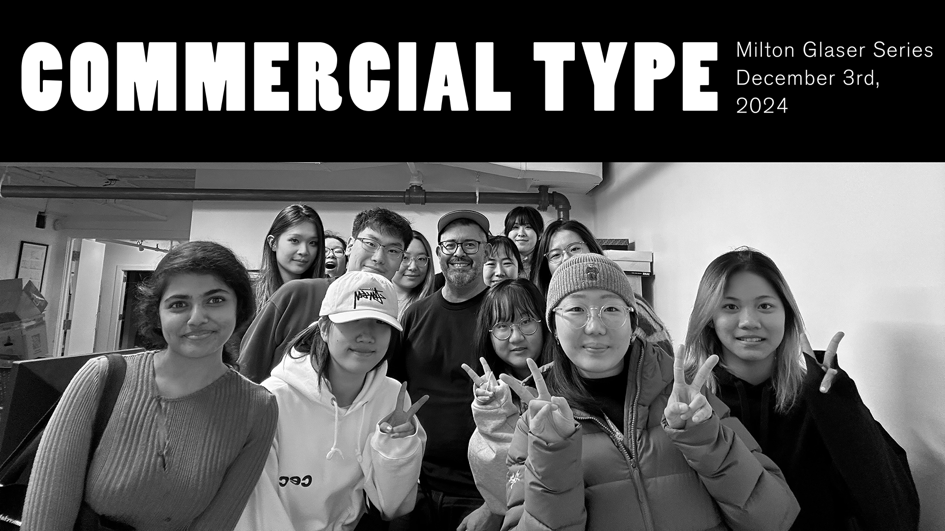 group photo of design students in a studio flashing peace signs