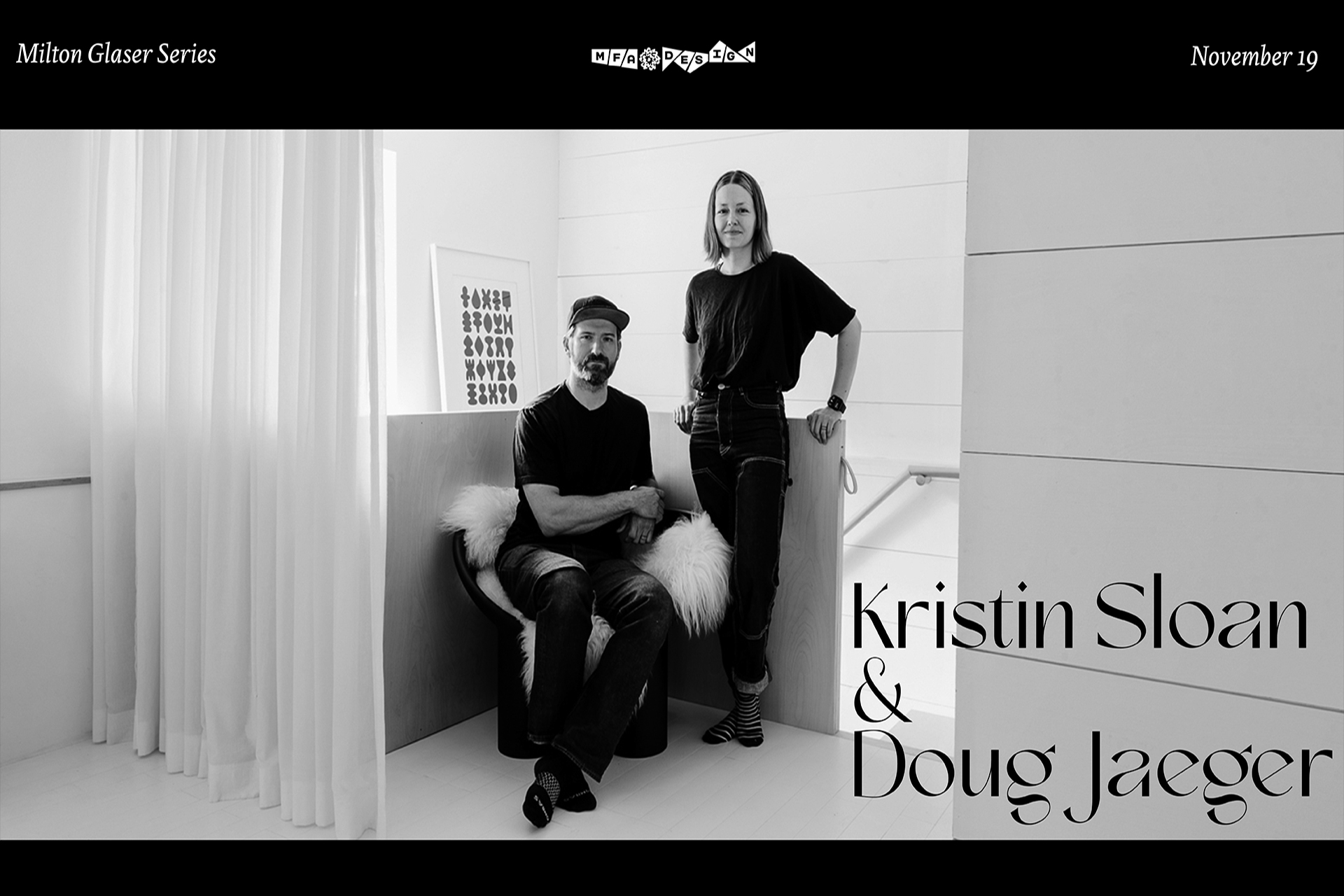 a man is sitting and woman is standing in a nice white room