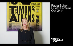 Designer Paula Scher standing in front of a large poster she designed
