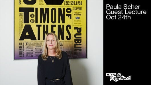 Designer Paula Scher standing in front of a large poster she designed