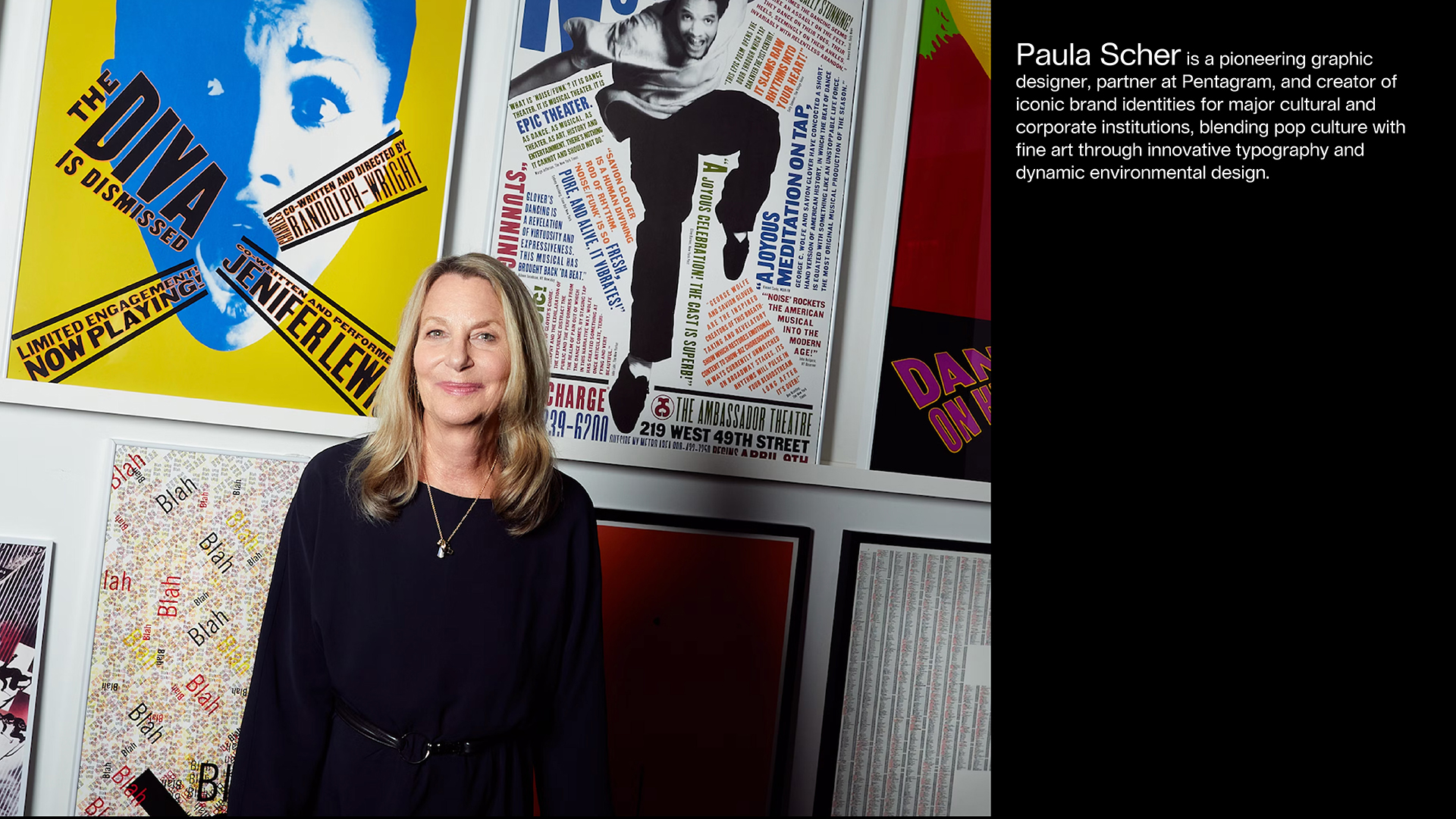 designer Paula Scher standing in front of her posters