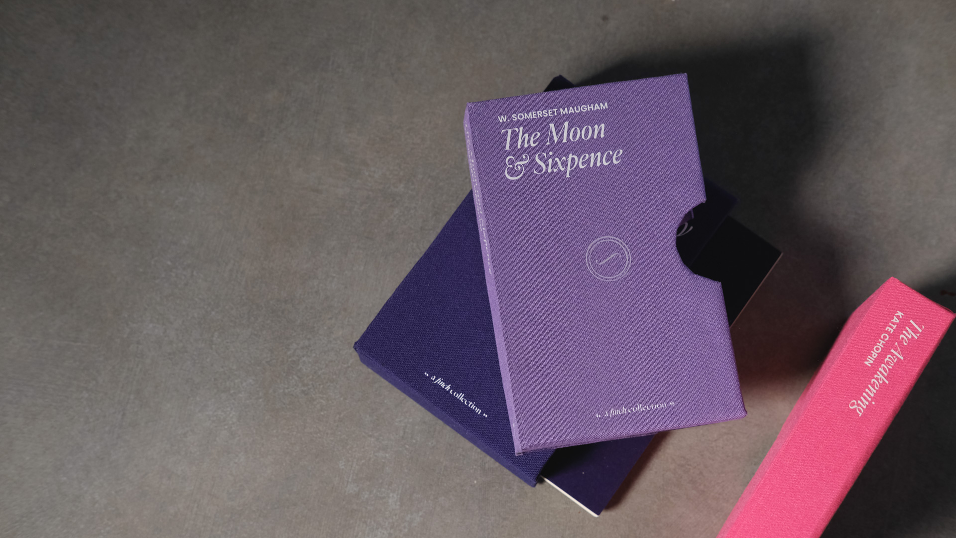 looking down on a table, threre are some miniature cases for books.
