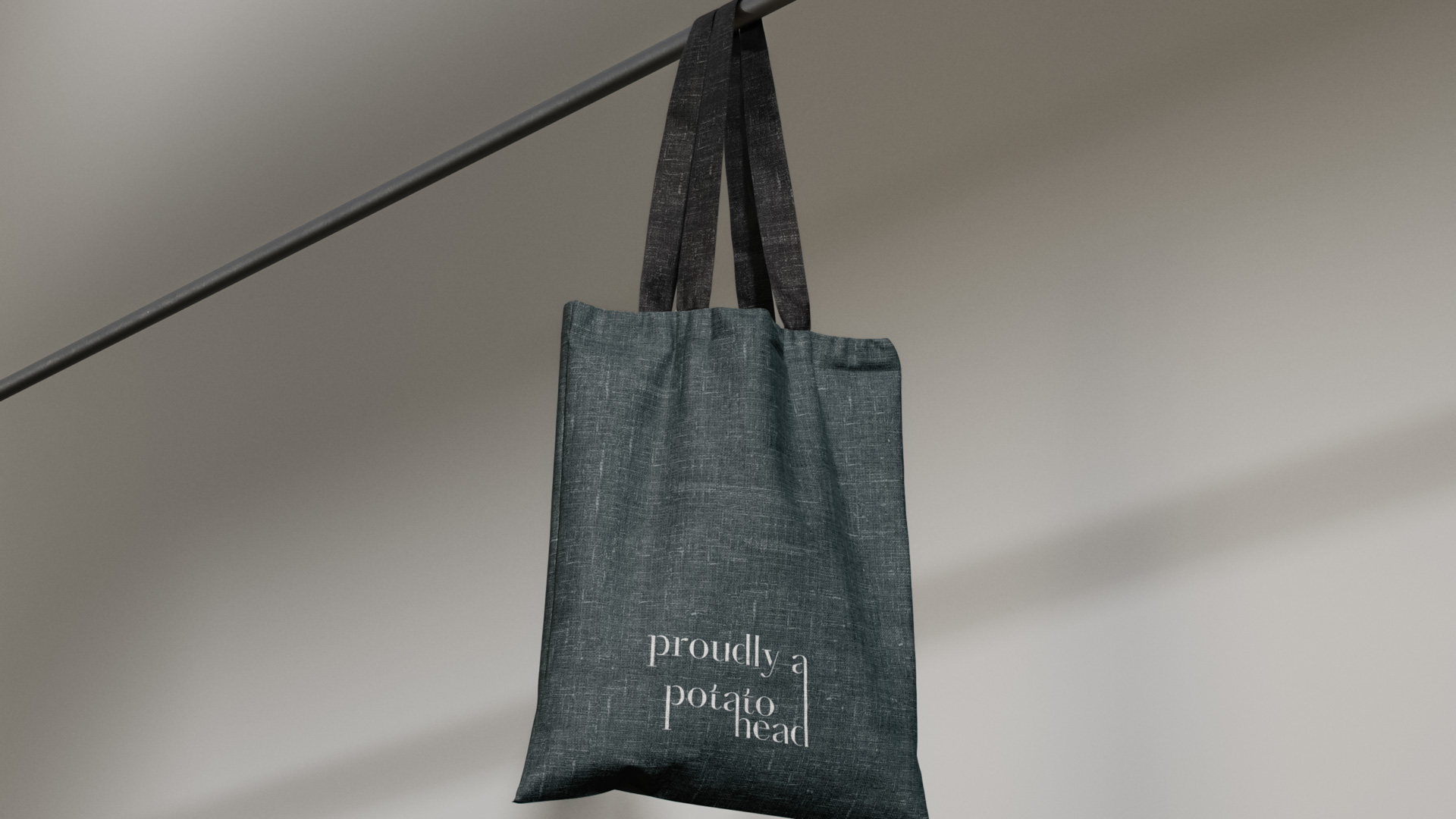 a bag hanging from a pole with the words Proudly Potato Head  on it