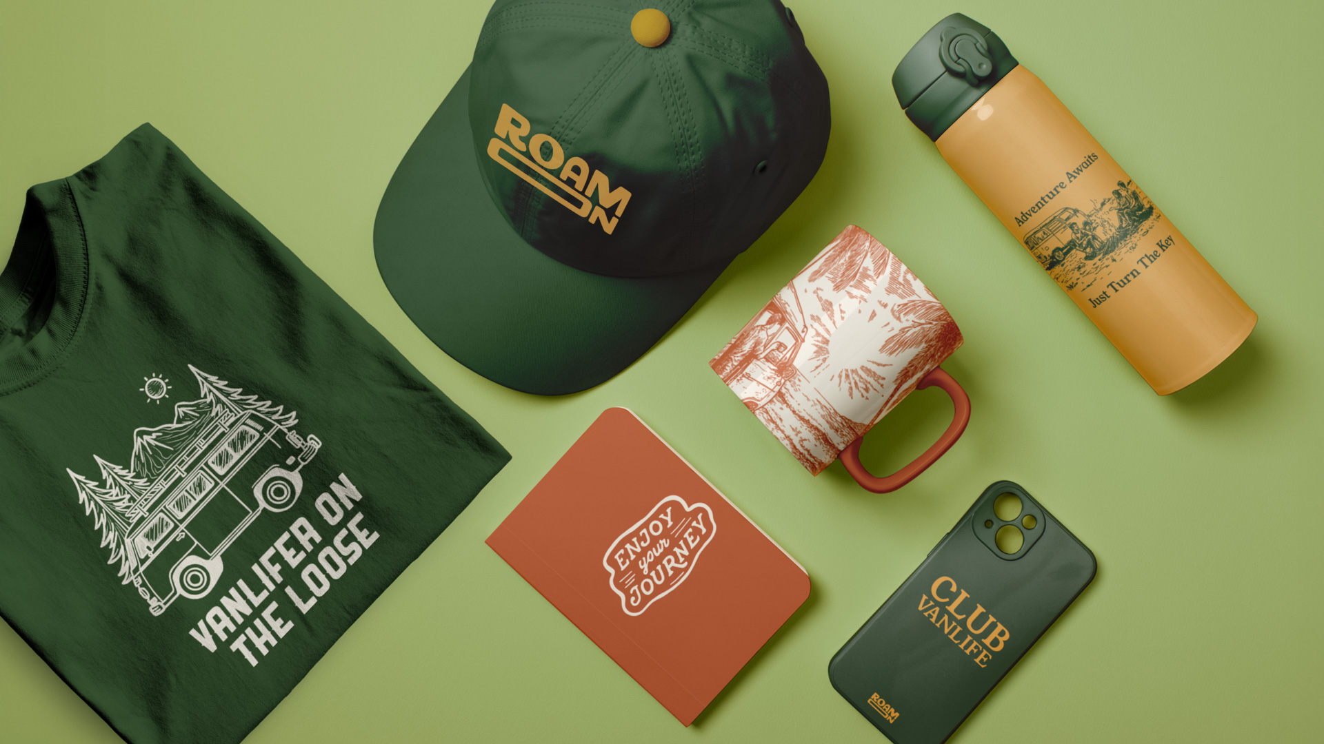 several items with the Roam On logo on a table, including a hat, a T-shirt, a mug, etc