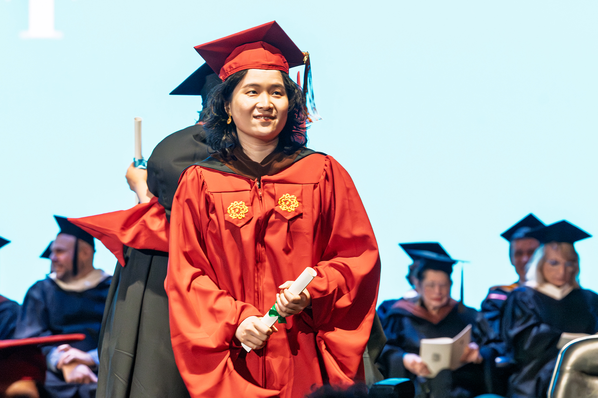 a student on stage getting her diploma