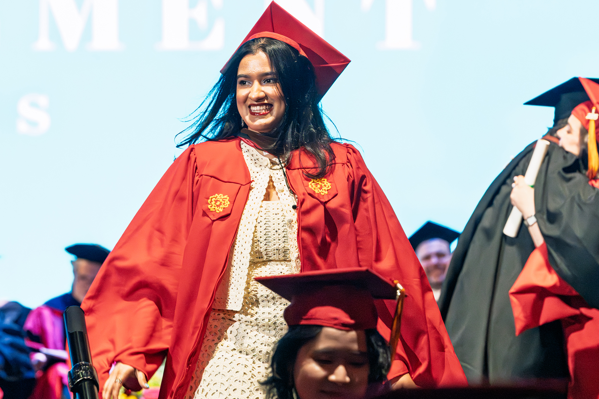 a student on stage getting her diploma