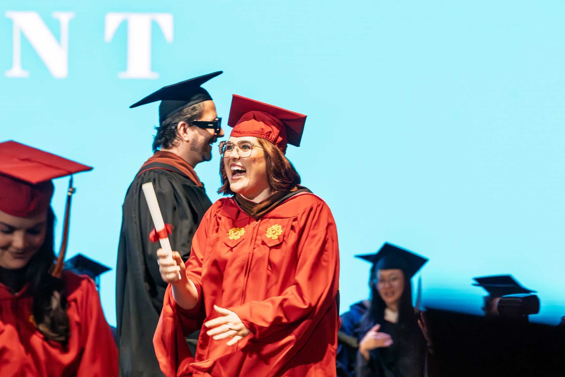 a student on stage getting her diploma