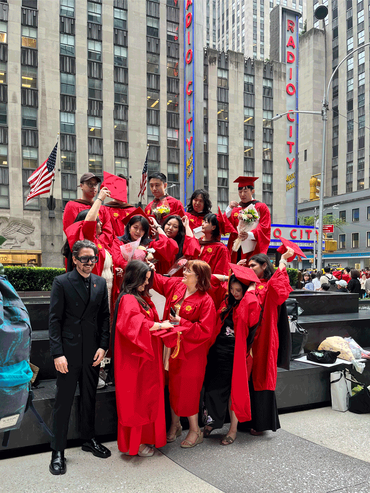 students post graduation throwing their caps in the air