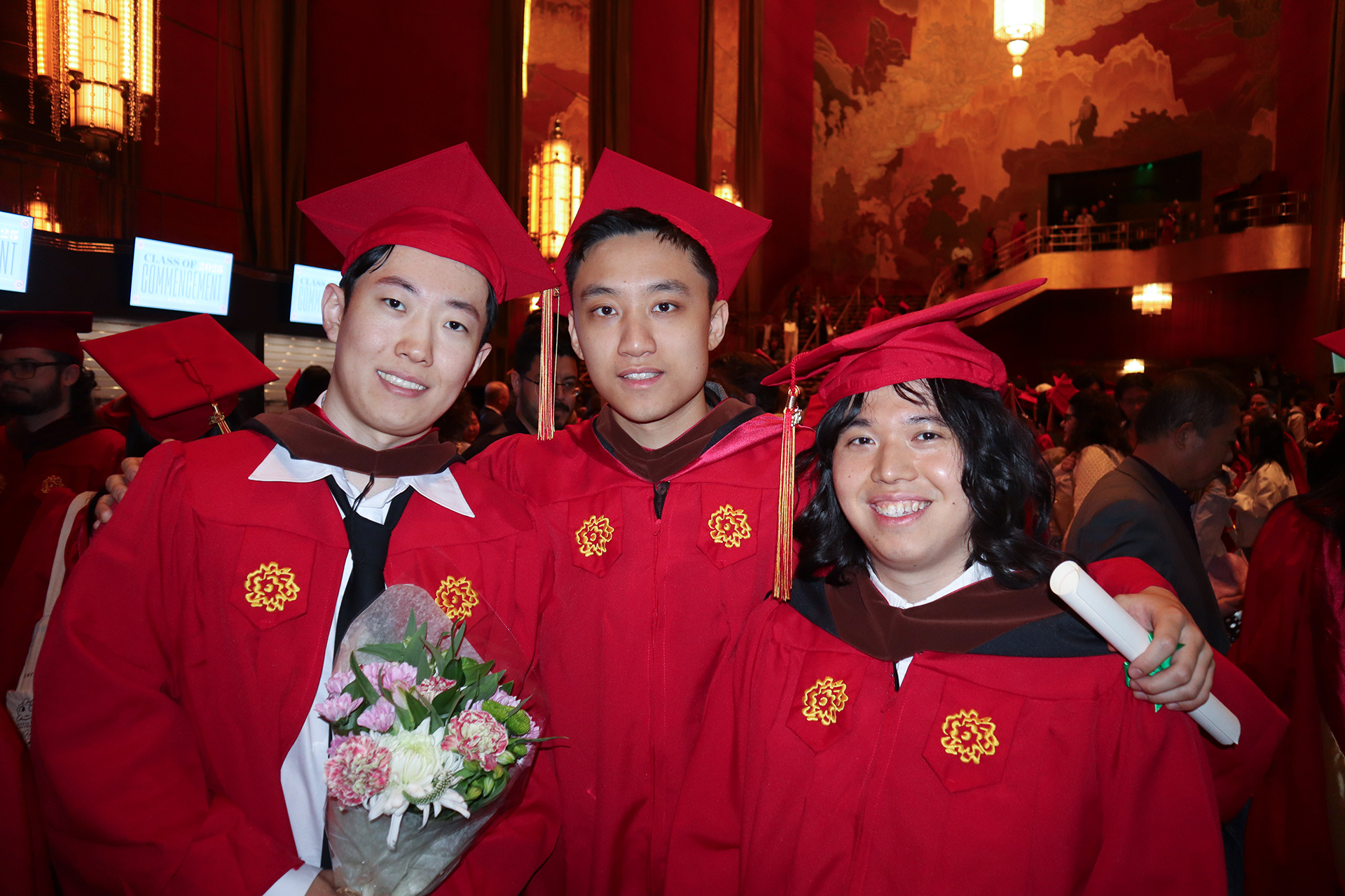 three students in radio City music hall posing for the camera