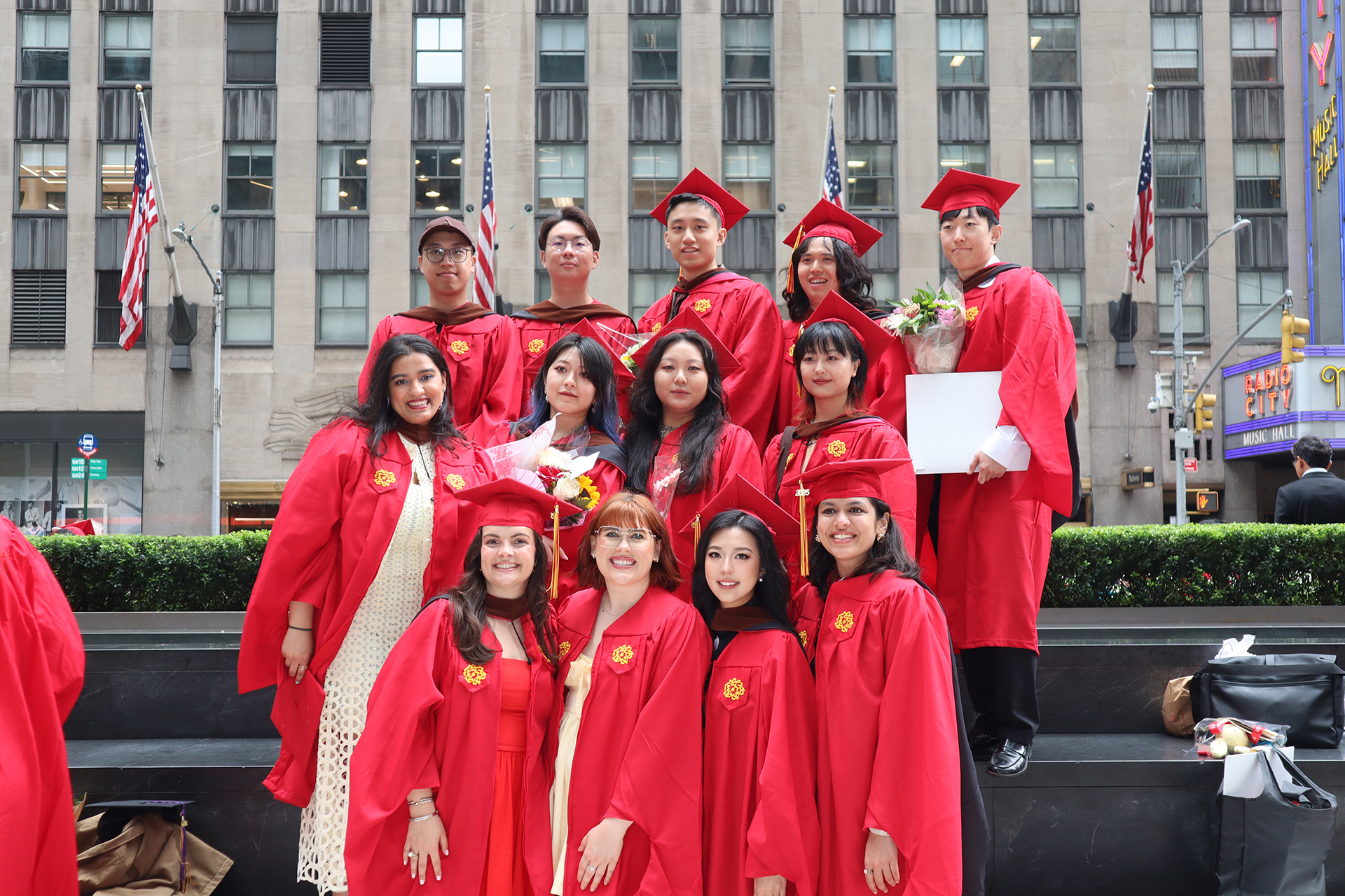 a group of students in commencement gowns posing for the camera