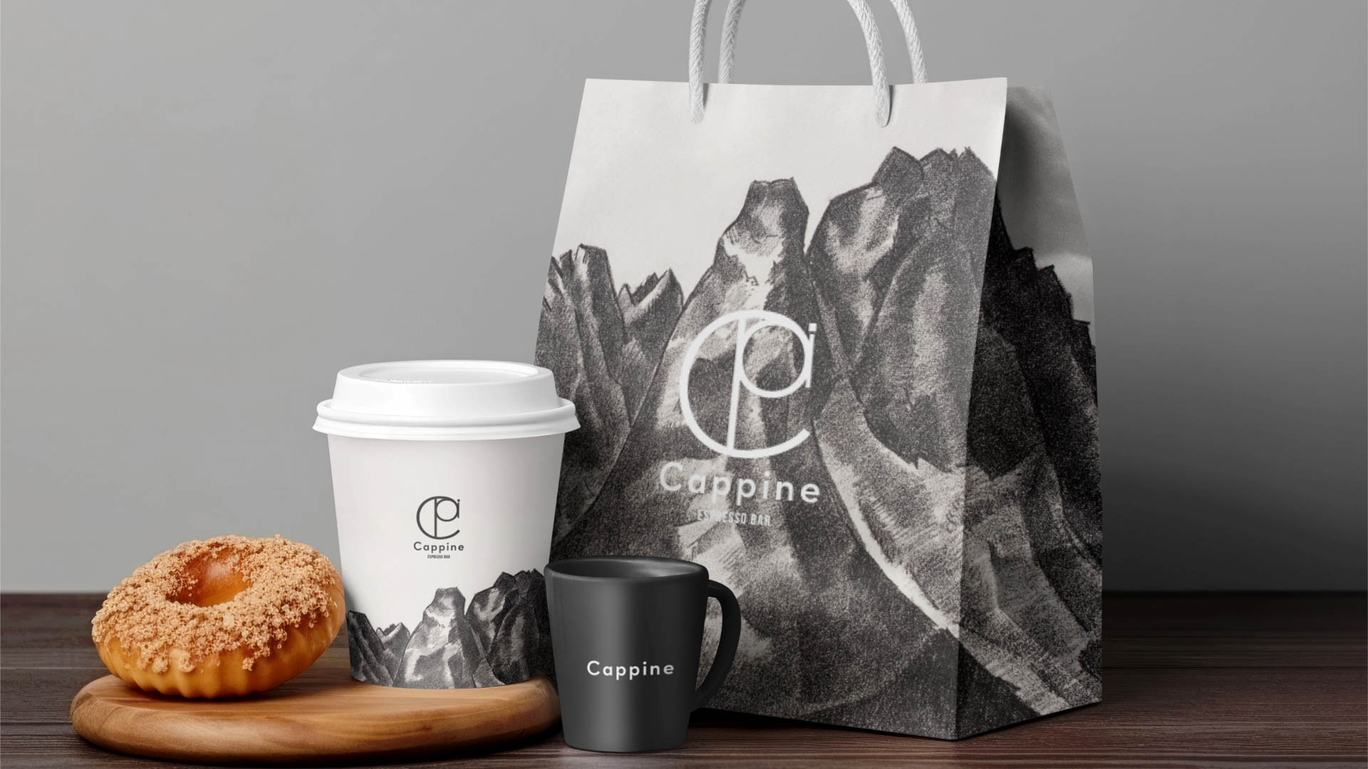 a pastry, a coffee and a paper bag on a table