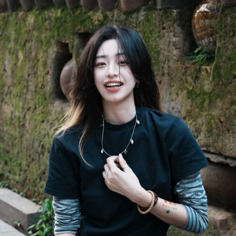 woman with long hair smiling at the camera