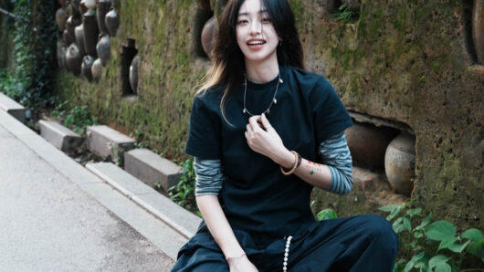 woman with long hair smiling at the camera