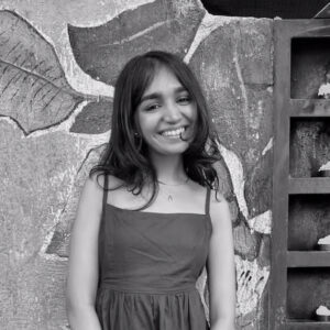 portrait of Anushri, black and white smiling woman - square
