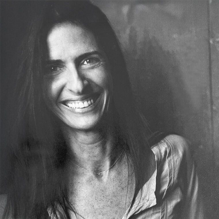 a low contrast black and white image of a long-haired woman.
