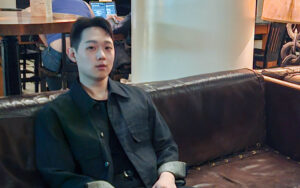 a man  in a black shirt looking at the camera