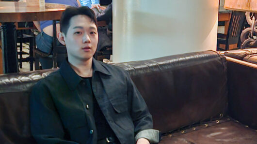 a man  in a black shirt looking at the camera