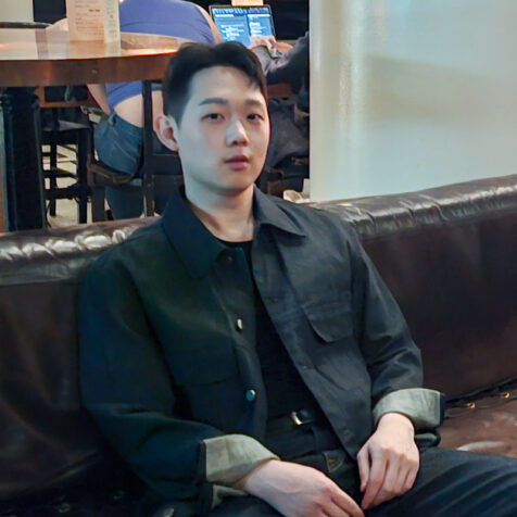 a man  in a black shirt looking at the camera