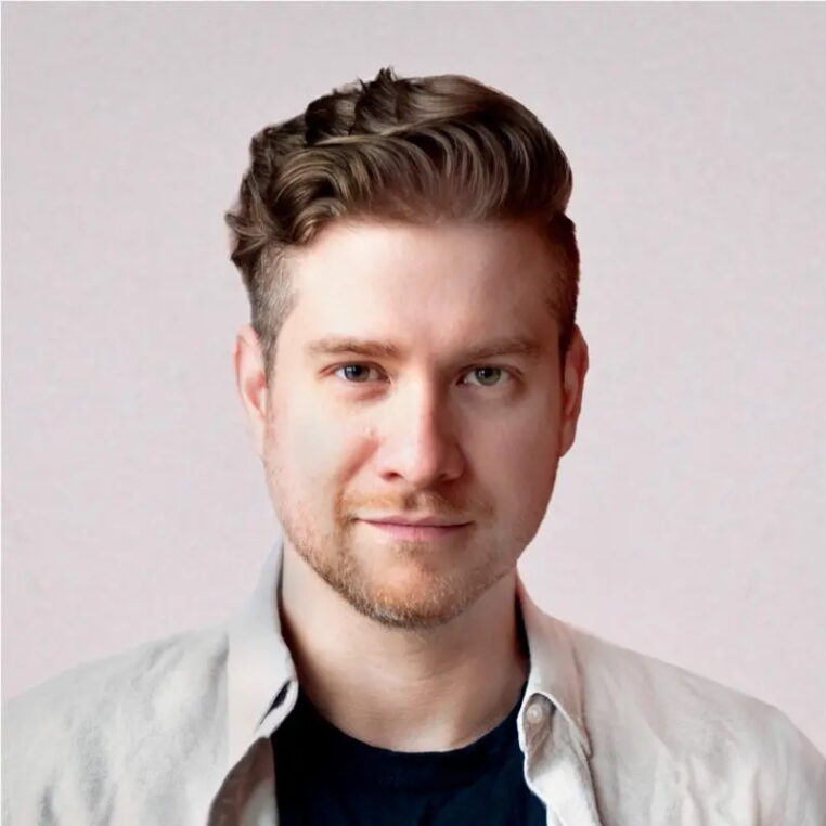 headshot of a man looking at the camera, white background