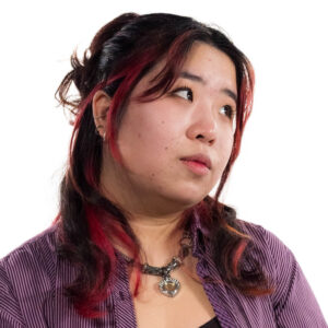 a woman with long hair looking off camera, white background
