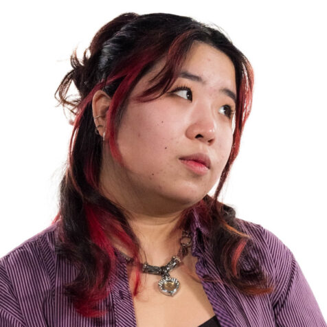 a woman with long hair looking off camera, white background