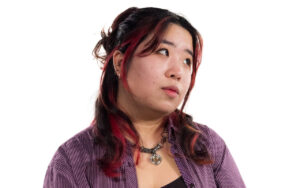 a woman with long hair looking off camera, white background