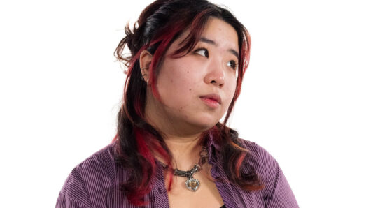a woman with long hair looking off camera, white background