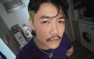 closeup of man with mustache looking at the camera