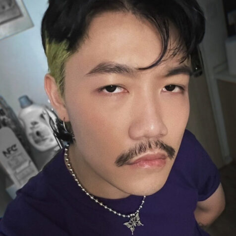 closeup of man with mustache looking at the camera