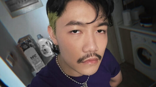 closeup of man with mustache looking at the camera
