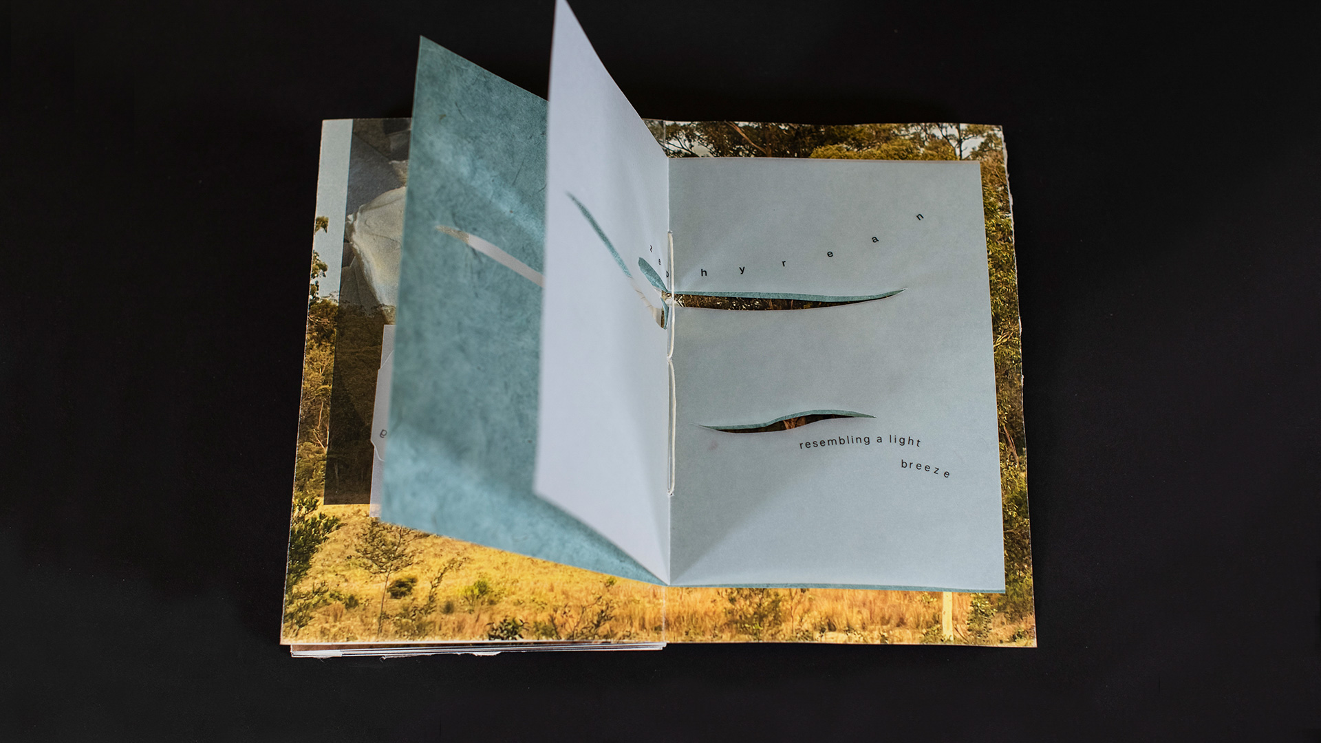 book open to page with illustration, black background