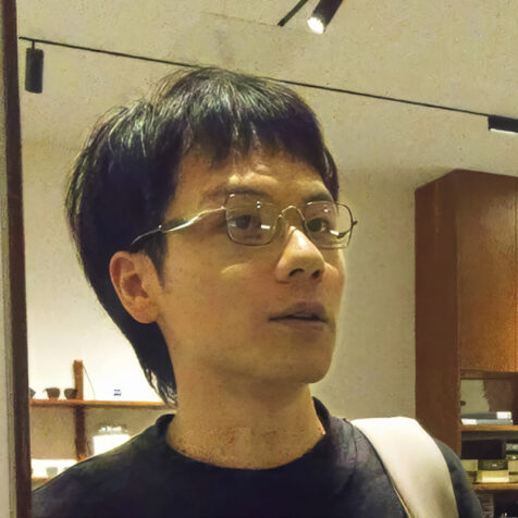 man with glasses and a black shirt