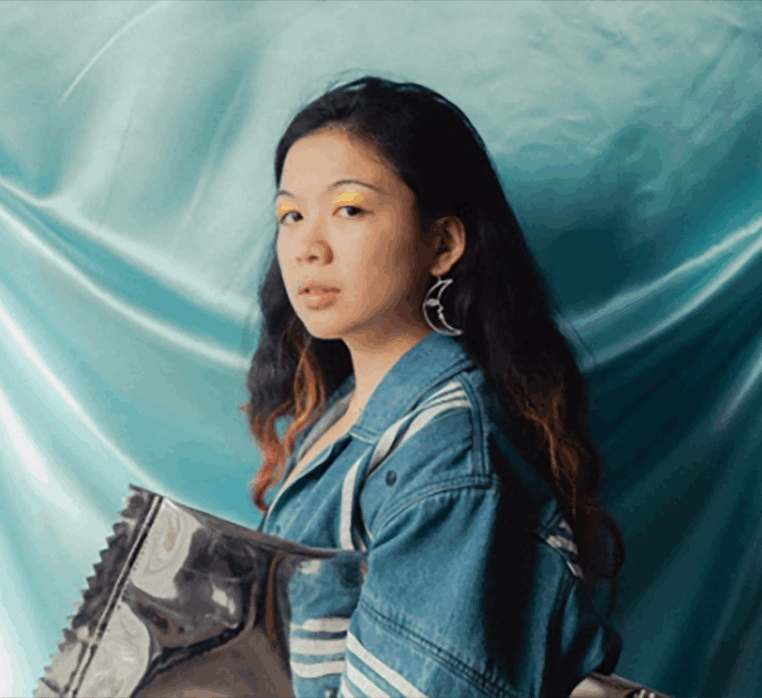portrait of a woman with long hair looking at the camera. fabric background