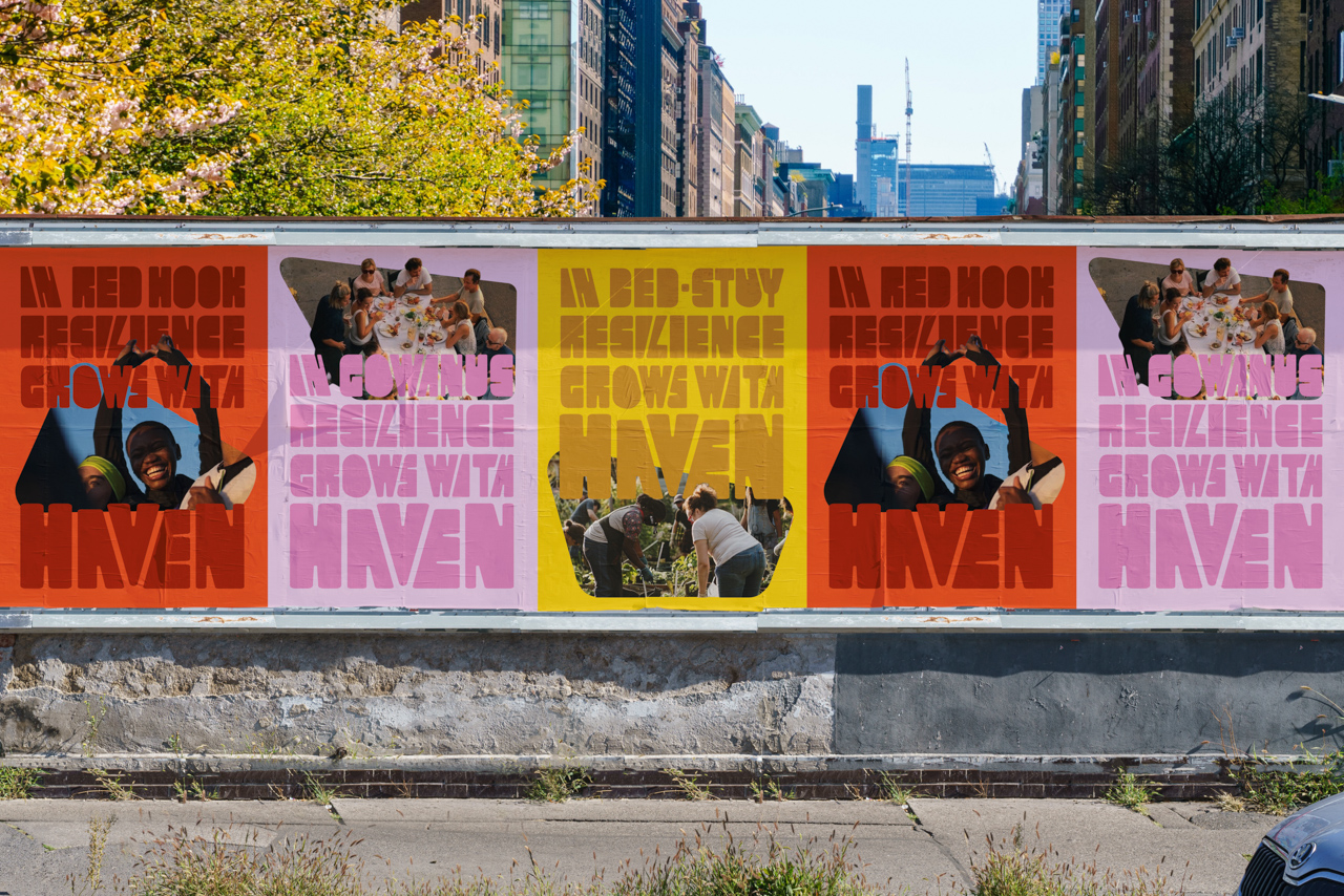 Large outdoor poster installation featuring colorful “HAVEN” community and resilience campaign graphics with photos of people gathered together.