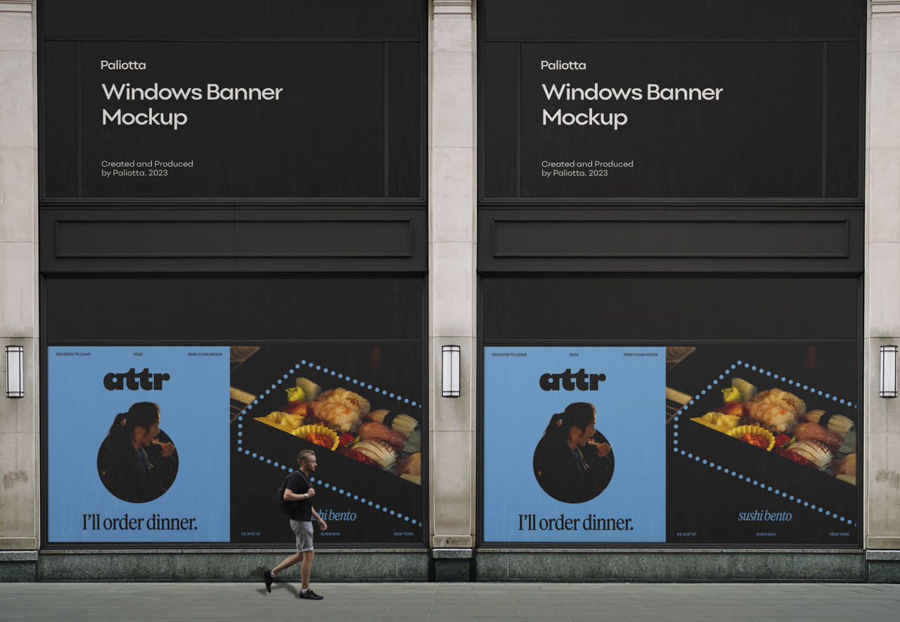 Large storefront window banners featuring food advertisements and “attr” branding on a city street with a pedestrian walking past.