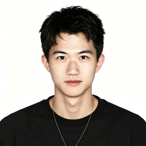 man in black looks at the camera. white background